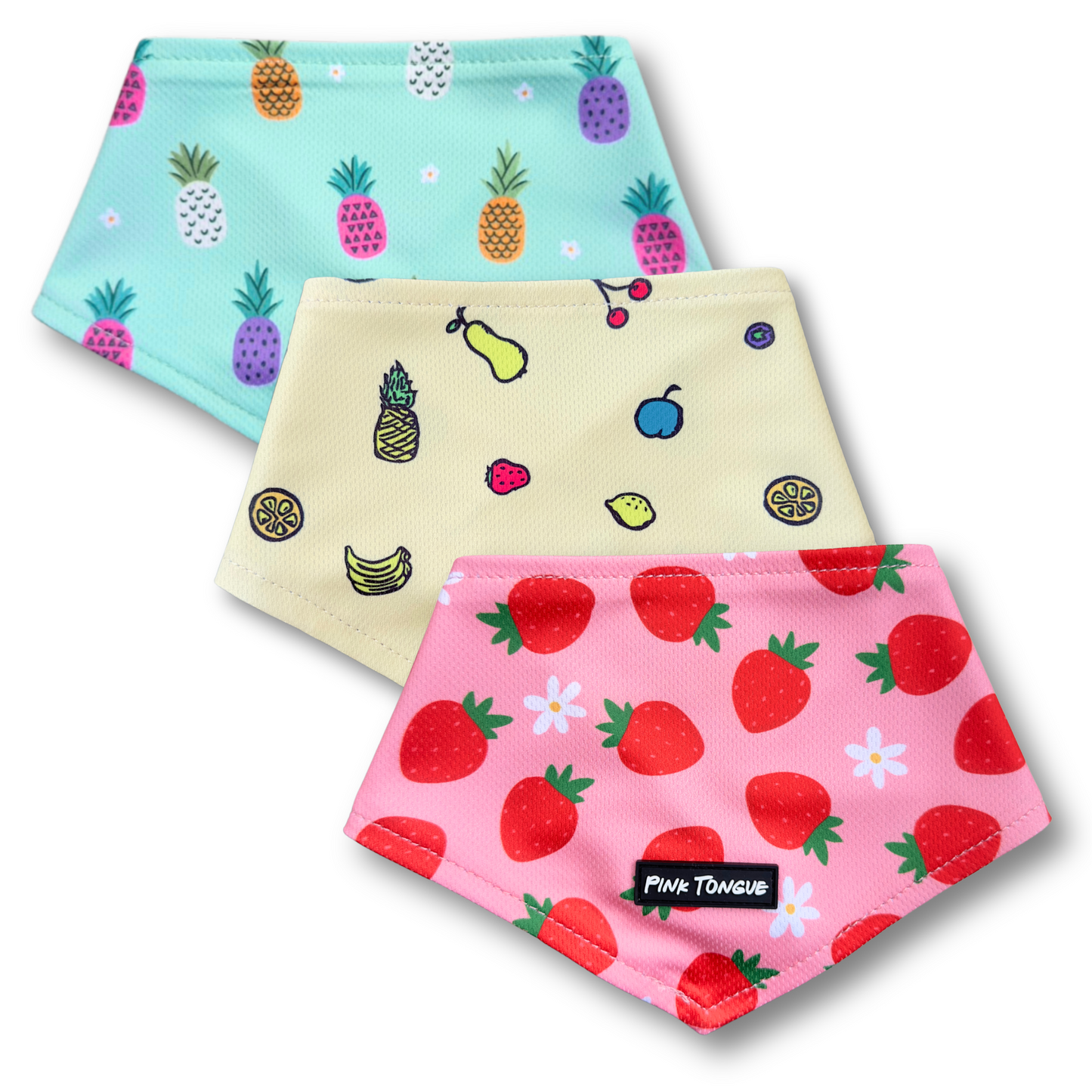 Three colorful dog bandanas with fruit patterns on a white background