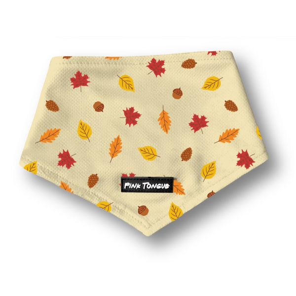 Beige dog bandana with autumn leaf pattern and 'Pink Tongue' label on a white background